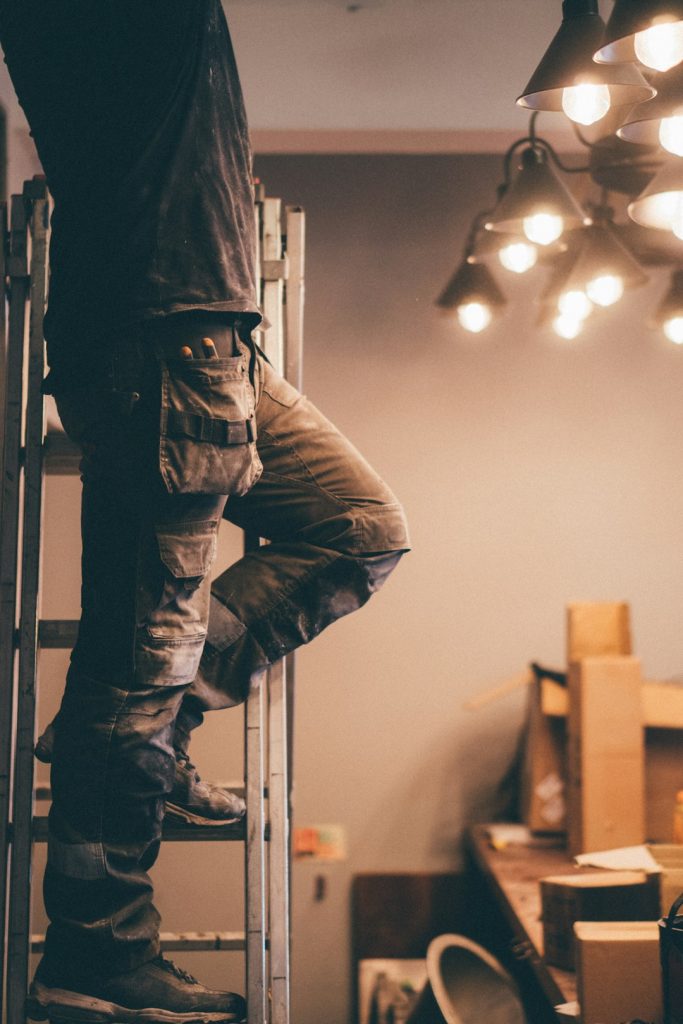Worker climbing ladder